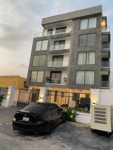 a black car parked in front of a building at Luxury 2 bedrooms Labone Loft suites in Accra