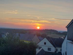 GornhausenにあるFeWo Kokopelli Mosel Hunsrückの家屋・屋根の町夕暮れ