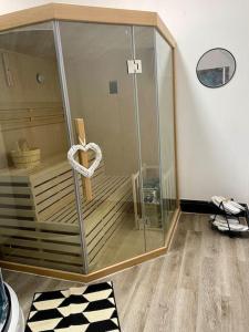 a glass enclosure with a heart in a room at Haven Hideout 4 Bed With Sauna, Cinema & Gym in Royton +83 photos