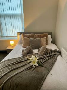 a bedroom with a bed with a flower on it at Haven Hideout 4 Bed With Sauna, Cinema & Gym in Royton