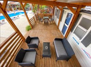 an overhead view of a deck with chairs and a pool at Mobilheim Camping 6 Personen Pool am Meer in Turanj