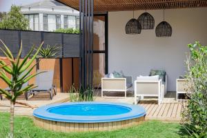 a patio with a blue pool in the middle of a yard at 4 Lulworth in Johannesburg +32 photos