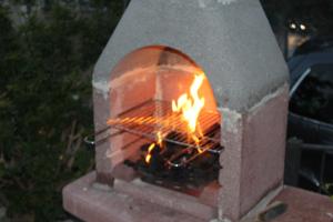 a brick oven with a fire in it at Residence Hotel Torresilvana in Vieste
