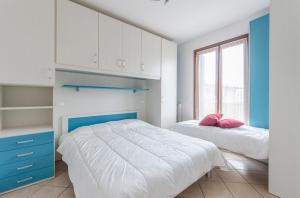 Кровать или кровати в номере Residence Villaggio dei Fiori con Piscina e Posto Spiaggia Incluso