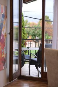 a sliding glass door leading to a patio with a table at Trón Apartman 2 in Siklós