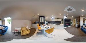 a kitchen and living room with a table and chairs at Robeen House in Killarney