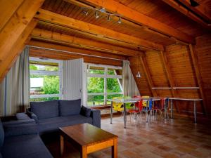 a living room with a couch and a table and chairs at Ferienhaus im Ostseeresort Dampland in perfekter Lage in Damp +80 photos