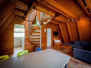 a living room with a table and a staircase at Ferienhaus im Ostseeresort Dampland in perfekter Lage in Damp