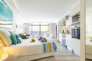 a bedroom with a large bed and a kitchen at HORIZON VACATION HOME - Guest House Gran Canaria in San Bartolomé de Tirajana +25 photos