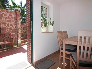 a room with a table and chairs on a patio at Wohnung in Boltenhagen am Ostseestrand in Boltenhagen