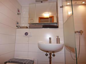 a bathroom with a sink and a mirror and a toilet at Wohnung in Boltenhagen am Ostseestrand in Boltenhagen +31 photos