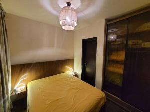 a bedroom with a yellow bed and a light at Healing & Relaxation Studio in Porto Sharm in Sharm El Sheikh +13 photos