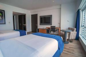 Postel nebo postele na pokoji v ubytování Wyndham Guayaquil, Puerto Santa Ana