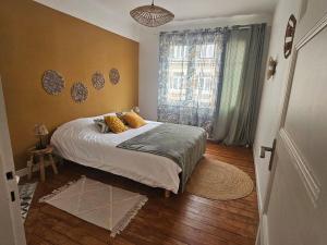 a bedroom with a bed with yellow pillows on it at Le port de calais in Calais