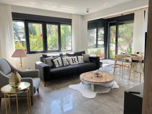 a living room with a couch and a table at Leos Apartments Apart2 in Side