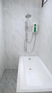 a white bathroom with a tub and a shower at ฮัก ณ หนองคายโคซี่วิลล์ Hug Na Nongkhai Cozy Ville in Nong Khai +35 photos