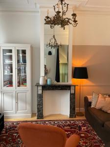 a living room with a fireplace and a couch at Holiday Home Jules in Antwerp