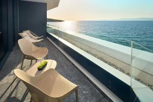 a balcony with chairs and tables on a cruise ship at Grand Hotel View in Postira
