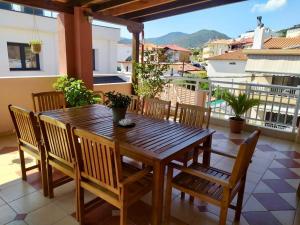 a wooden table and chairs on a balcony at Aurora House in Sarti +12 photos
