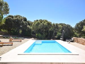 a swimming pool in a yard with trees at Tranquil Poolside Getaway in Mandre +23 photos