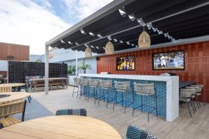 a restaurant with a bar and tables and chairs at Blueground Long Beach pool courtyard nr shops LAX-1259 in Los Angeles