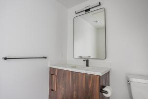 a bathroom with a sink and a mirror at Blueground Long Beach pool gym near bars LAX-1260 in Los Angeles +27 photos