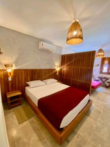 a bedroom with a large bed in a room at Casa Pitanga Flat in Jericoacoara