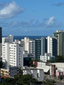 a city skyline with tall buildings and the ocean at Cantinho da Carol - Pituba - Localização Perfeita! in Salvador