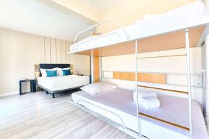 a bedroom with two bunk beds in it at TRYP by Wyndham Lisboa Caparica Mar in Costa da Caparica
