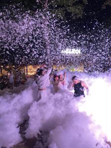 a group of people playing in the snow with a fire hydrant at Manawari Beach Resort in Caliclic