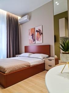 a bedroom with a bed and a mirror at Meri Apartment in Tirana