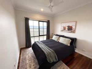 a bedroom with a large bed and a window at Golden Valley - Steels Creek in Steels Creek