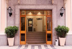 a front door of a building with two potted plants at Hotel Regina Rio de Janeiro in Rio de Janeiro