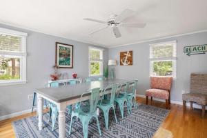 a dining room with a table and chairs at Game Room Walk to Nantucket Sound in Chatham +34 photos