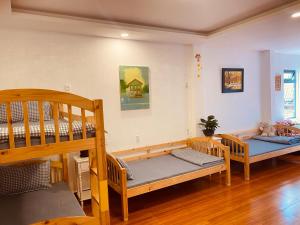 two bunk beds in a room with wooden floors at BắpHouseHomestay in Da Lat