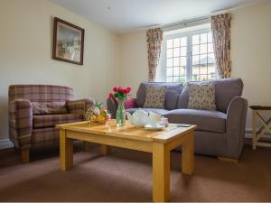 a living room with a couch and a coffee table at Emma Dent in Winchcombe +17 photos