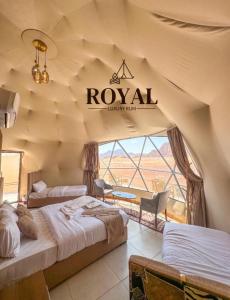 a room with two beds and a sign on the wall at ROYAL luxury rum in Wadi Rum