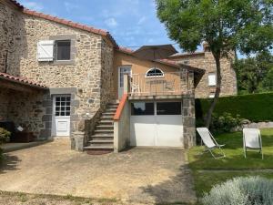 a house with a balcony and a garage at Holiday Home Saint-Beauzire near Pauillac Castle in Saint-Beauzire