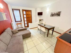 a living room with a couch and a table at In castello 1984 in Rovato