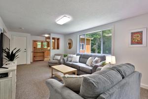 a living room with a couch and a table at The Mendon Cottage - Charming Vermont Home Close to Pico, Ski Rental Deals! in Mendon