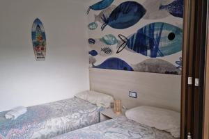 a room with two beds and a painting on the wall at Palmeres in Torroella de Montgrí +26 photos