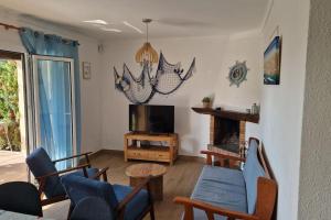a living room with a tv and a table and chairs at Palmeres in Torroella de Montgrí