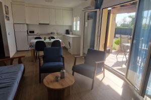 a kitchen and living room with a table and chairs at Palmeres in Torroella de Montgrí