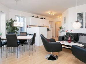 a living room and dining room with a table and chairs at 5 person holiday home on a holiday park in Bogense in Bogense