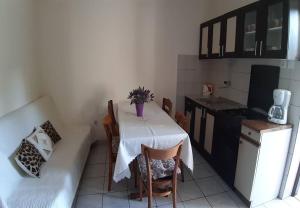 a small kitchen with a table and a couch at Apartments Mar in Sutivan +24 photos