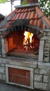 a brick oven with a fire in it at Apartments Mar in Sutivan