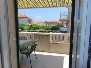 a view of a balcony with a table and chairs at Apartment Fran in Postira