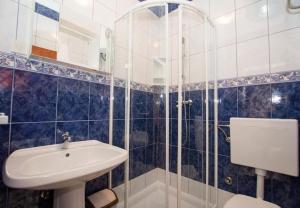 a bathroom with a sink and a toilet and a shower at Apartments Juri in Sućuraj +70 photos