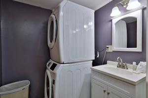 a white refrigerator in a bathroom with a sink at West Park Chalet - Large Vermont Ski Home - Great for Groups! Hot tub, games, ski rental ticket deals! in Killington +44 photos