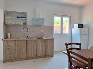 a kitchen with a sink and a refrigerator at Apartment Graciela in Gradac